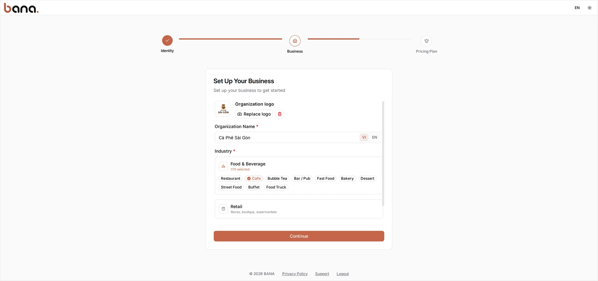 The Set Up Your Business step: the Cà Phê Sài Gòn logo uploaded, Organization Name 'Cà Phê Sài Gòn' on the VI tab of the VI/EN toggle, and the Food & Beverage industry card open with the Cafe sector chip selected — 1/10 selected