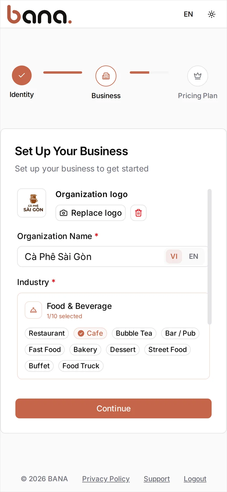 The Set Up Your Business step: the Cà Phê Sài Gòn logo uploaded, Organization Name 'Cà Phê Sài Gòn' on the VI tab of the VI/EN toggle, and the Food & Beverage industry card open with the Cafe sector chip selected — 1/10 selected