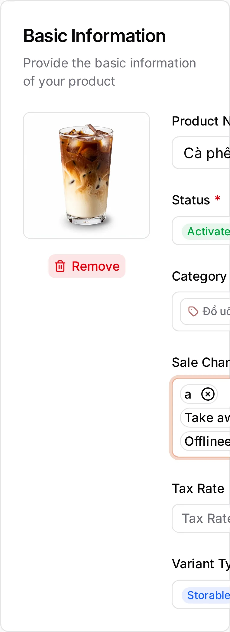 The Create Product page: a photo of a latte uploaded beside a Remove button, Product Name 'Cà phê Latte' entered on both sides of the VI/EN toggle with EN currently showing, Status Activated, Category Đồ uống, Sale Channel showing all three of Offline, Take away and GrabFood, an empty Tax Rate, and Variant Type Storable. The POS Live Preview on the right shows the same photo and name in Desktop and Mobile shapes at 0 đ